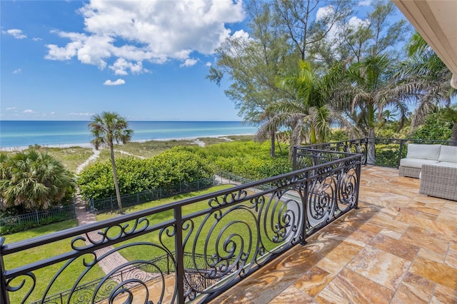 balcony featuring a water view and a view of the beach