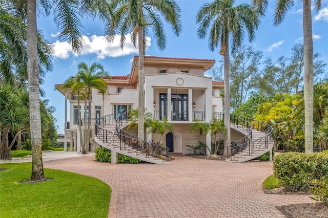 mediterranean / spanish-style house with a porch and french doors