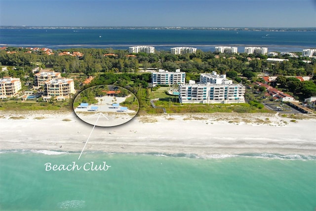 drone / aerial view featuring a view of the beach and a water view