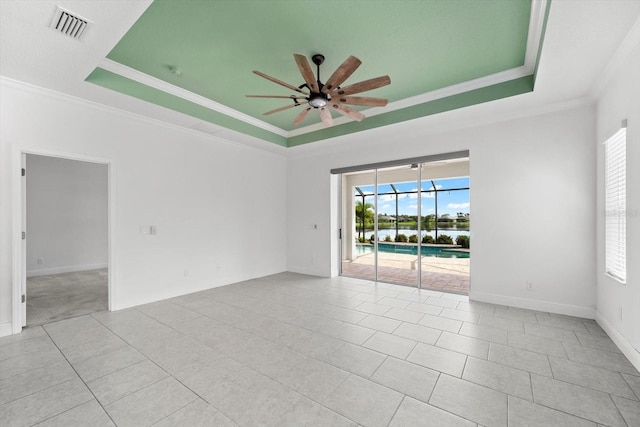 4704 Foxtail Dr, Parrish, FL 34219 - tiled spare room with a raised ceiling, ceiling fan, ornamental molding, a water view, and baseboards
