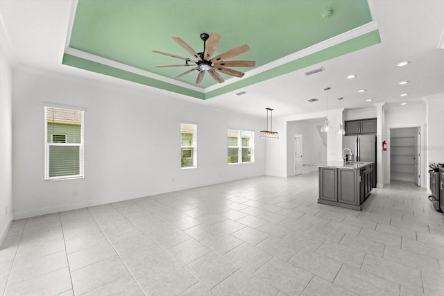 interior space with a tray ceiling and a healthy amount of sunlight