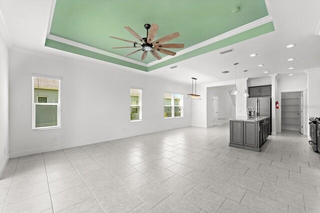4704 Foxtail Dr, Parrish, FL 34219 - unfurnished living room with a raised ceiling, ceiling fan, plenty of natural light, crown molding, and recessed lighting