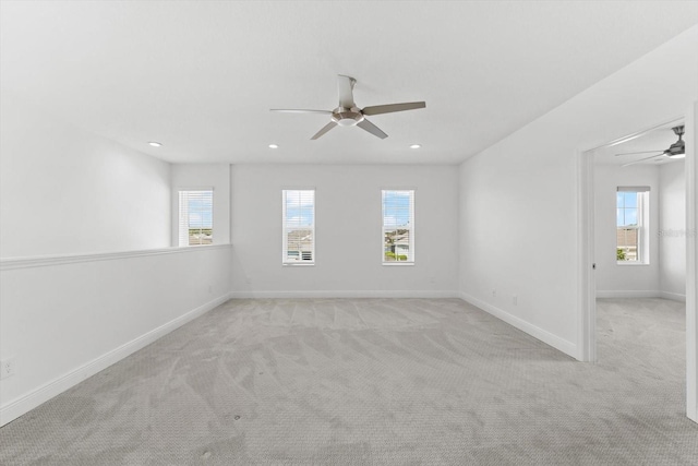 spare room with light carpet and ceiling fan