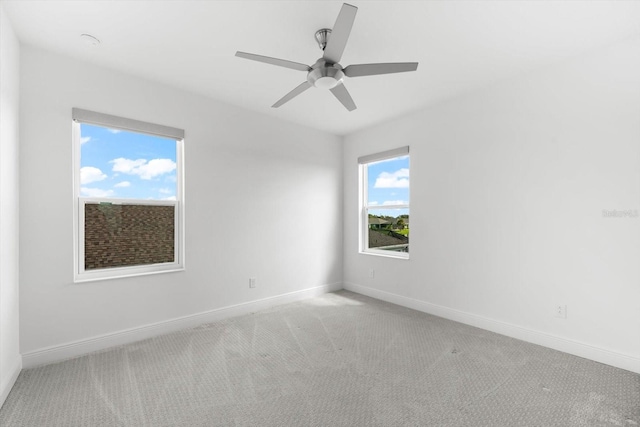 unfurnished room with light carpet and ceiling fan