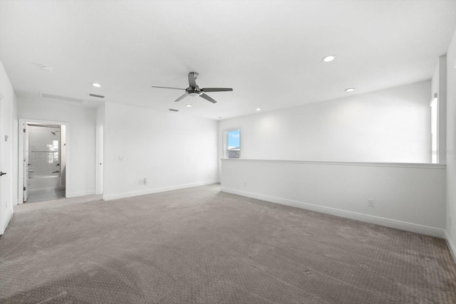 unfurnished room featuring ceiling fan and carpet