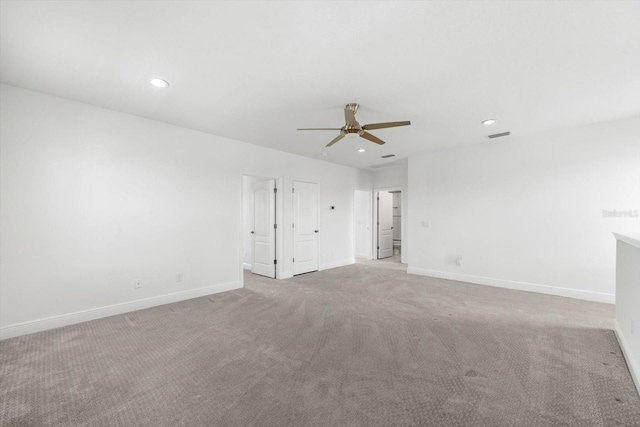 carpeted spare room with ceiling fan