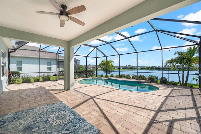 view of pool featuring a water view, a patio area, ceiling fan, and a lanai