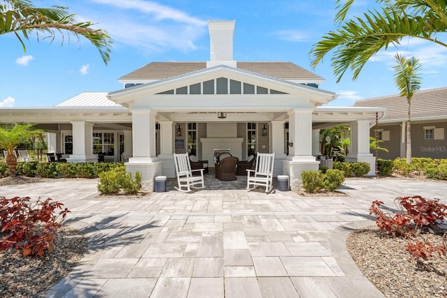 rear view of property featuring a porch