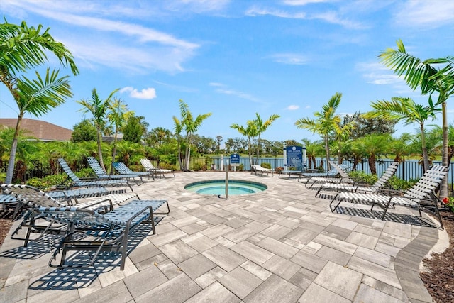 view of swimming pool featuring a community hot tub and a patio