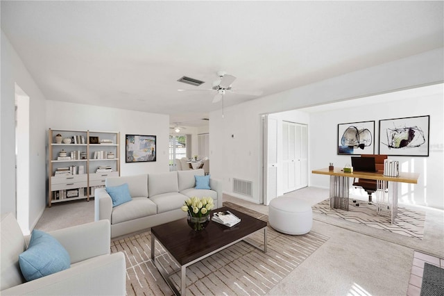 living room with light carpet and ceiling fan