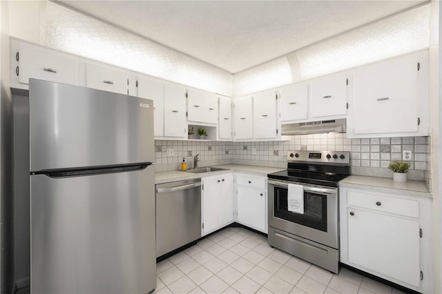 kitchen with white cabinetry, stainless steel appliances, ventilation hood, and backsplash