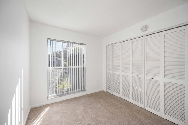 unfurnished bedroom featuring a closet and carpet