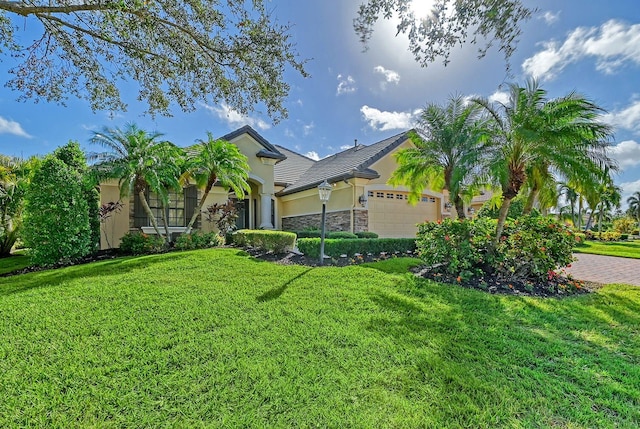 view of front of property featuring a garage and a front yard