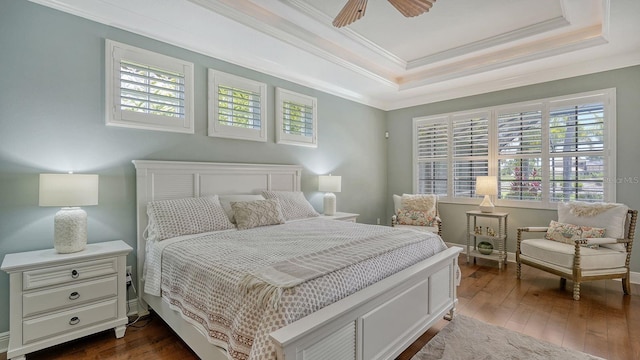 bedroom with ceiling fan, multiple windows, dark hardwood / wood-style flooring, and ornamental molding