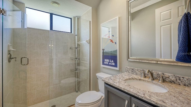 bathroom with walk in shower, vanity, and toilet