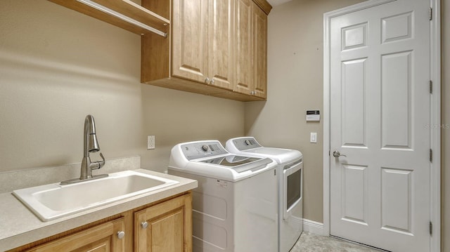 laundry room with washer and clothes dryer, cabinets, sink, and light tile patterned flooring