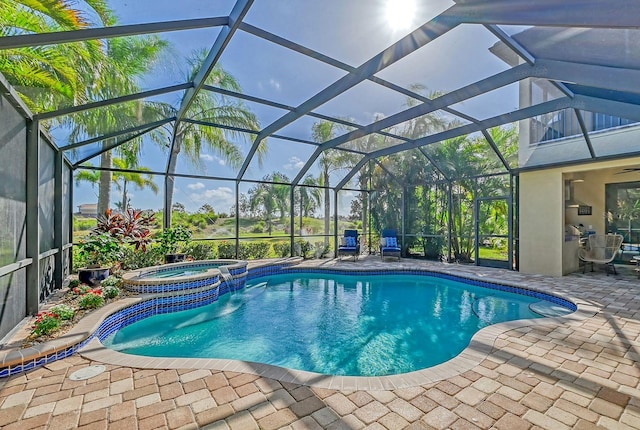 view of pool featuring glass enclosure, a patio, and an in ground hot tub