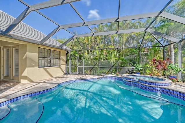 view of pool with a lanai, a patio, and an in ground hot tub