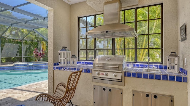 exterior space featuring grilling area, an in ground hot tub, sink, glass enclosure, and a patio