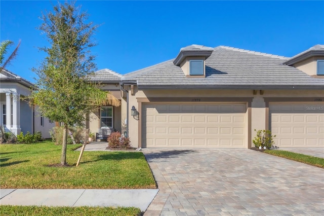 view of front of home with a garage and a front yard