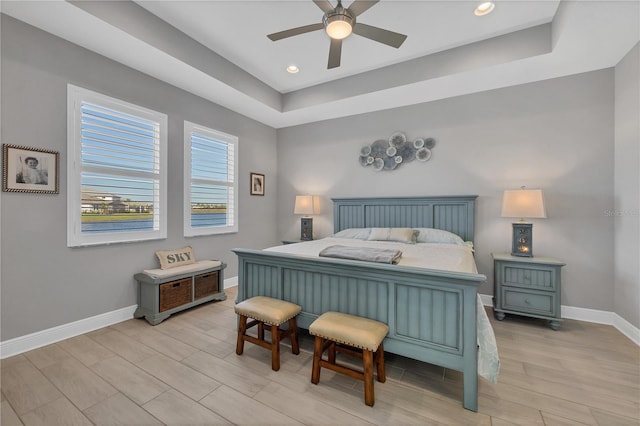 bedroom featuring a tray ceiling and ceiling fan