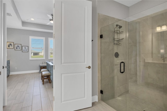 bathroom with ceiling fan and a shower with door