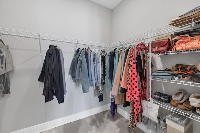 spacious closet featuring hardwood / wood-style floors