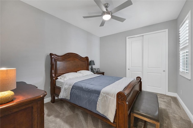 carpeted bedroom featuring ceiling fan and a closet