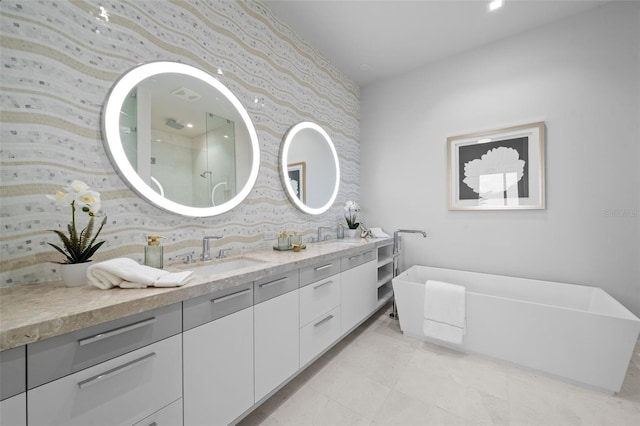 bathroom with a bathtub, vanity, and tasteful backsplash