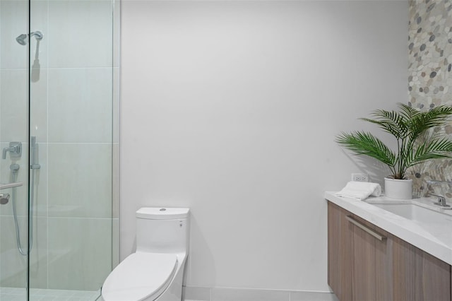 bathroom with a shower with shower door, vanity, and toilet