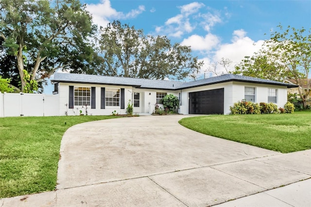 ranch-style house featuring a front lawn and a garage