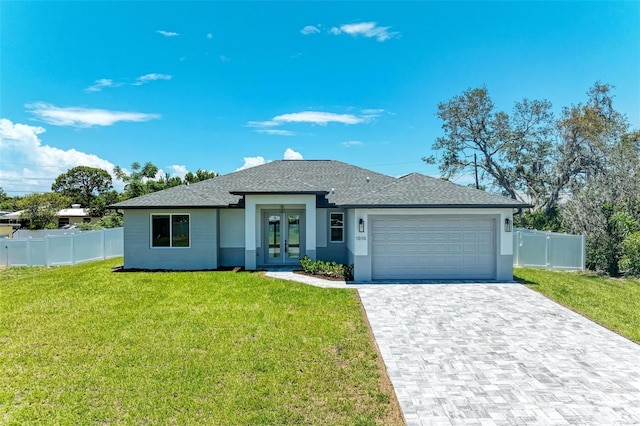1010 Acadia Rd, Venice, FL 34293 - view of front of property with french doors, an attached garage, stucco siding, decorative driveway, and a shingled roof