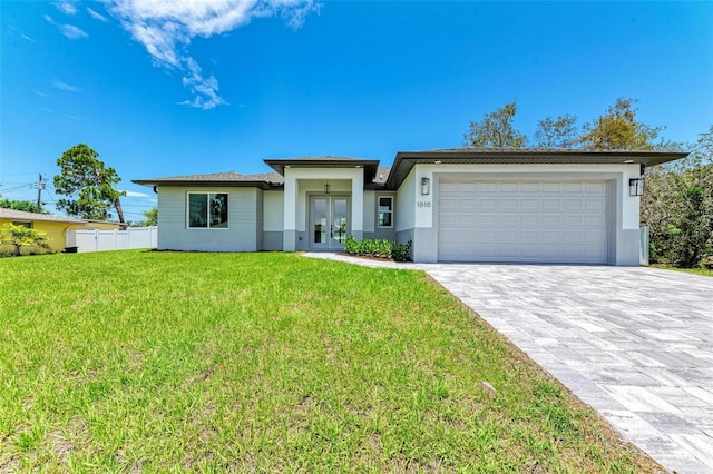 view of front facade with a garage and a front lawn