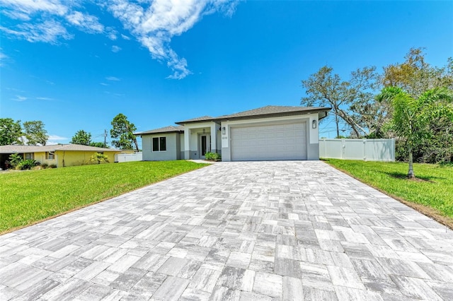 view of front of property with a garage and a front yard