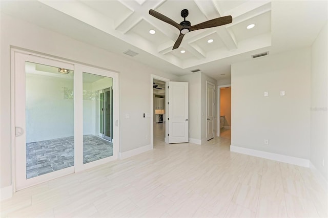 empty room featuring coffered ceiling, ceiling fan, and beam ceiling