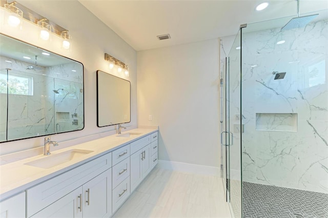 bathroom with vanity and a shower with door