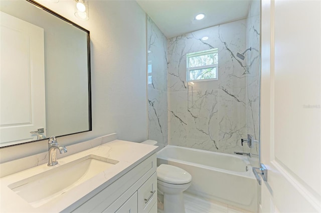 full bathroom featuring vanity, tiled shower / bath combo, and toilet