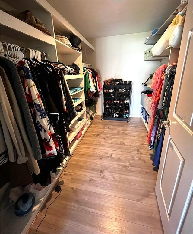 walk in closet featuring light hardwood / wood-style flooring