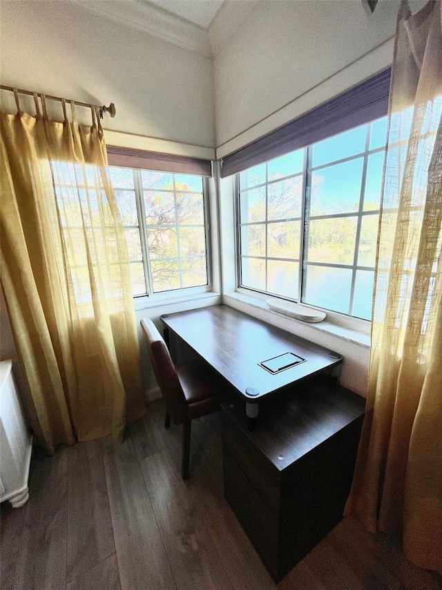 dining area featuring breakfast area, hardwood / wood-style floors, and ornamental molding