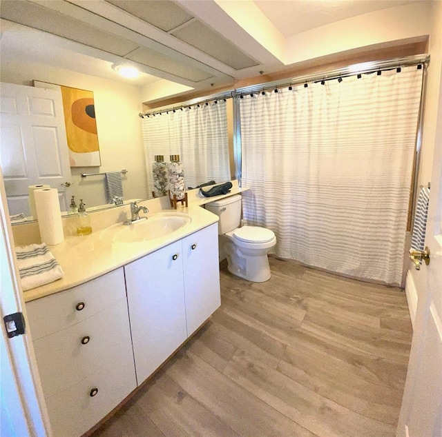 bathroom with vanity, hardwood / wood-style flooring, toilet, and a shower with shower curtain