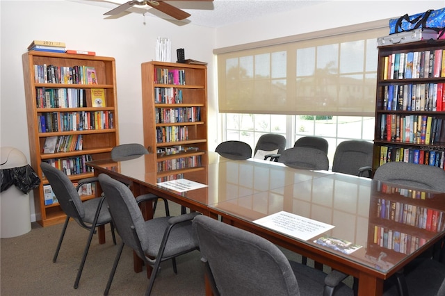 carpeted home office with ceiling fan