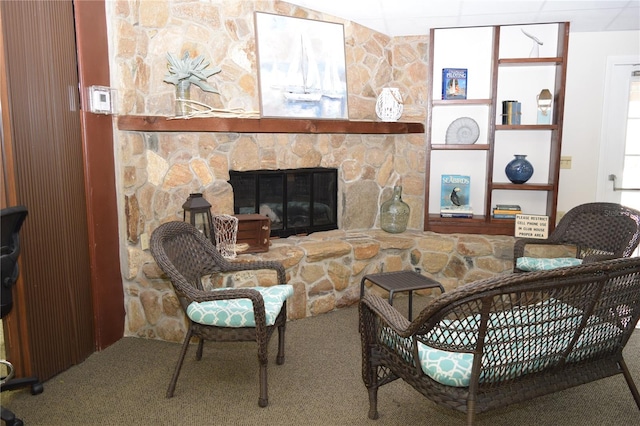 living room with a fireplace and carpet floors