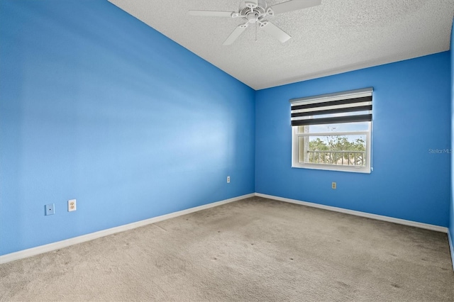 unfurnished room featuring a textured ceiling, carpet floors, and ceiling fan