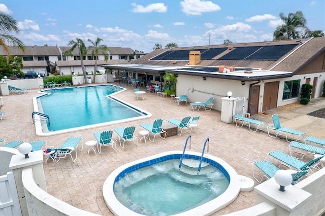 view of pool featuring a patio area and a hot tub