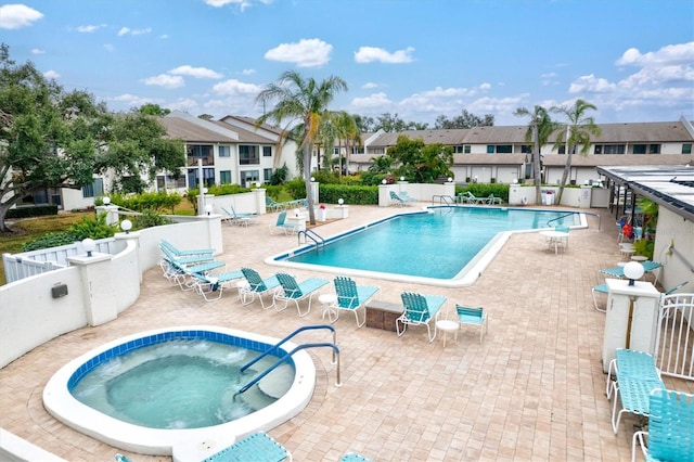 view of swimming pool featuring a community hot tub and a patio