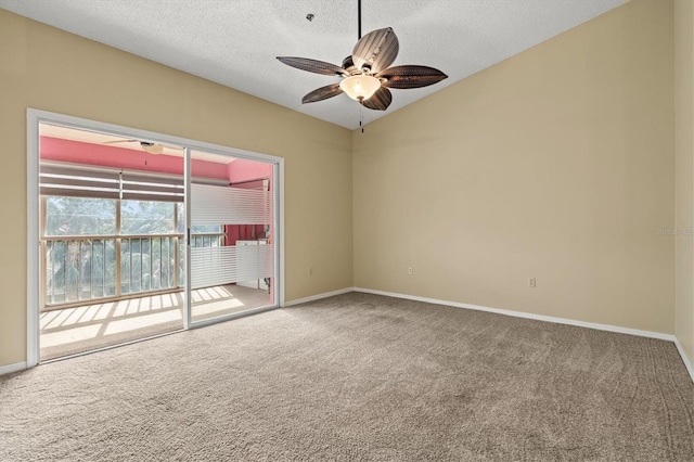 carpeted spare room featuring ceiling fan and a textured ceiling