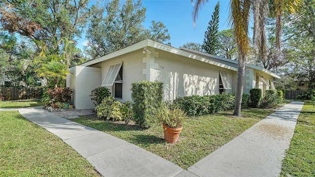 view of property exterior with a lawn