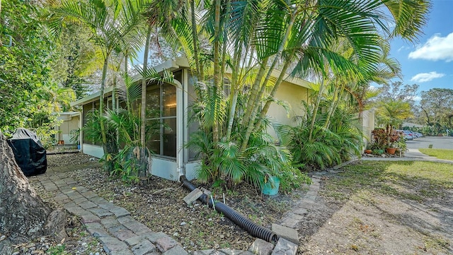 view of side of property with a sunroom