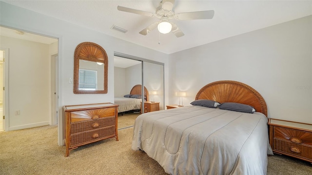 carpeted bedroom featuring a closet and ceiling fan