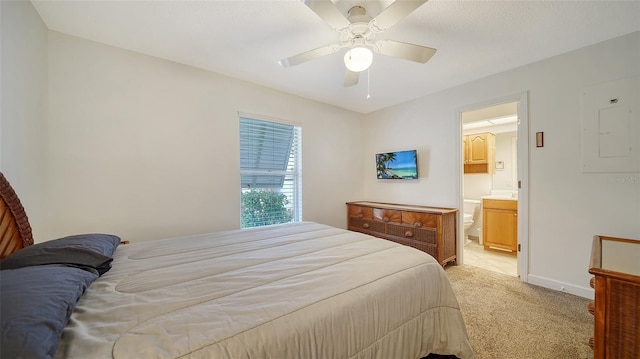 carpeted bedroom featuring electric panel, ceiling fan, and connected bathroom